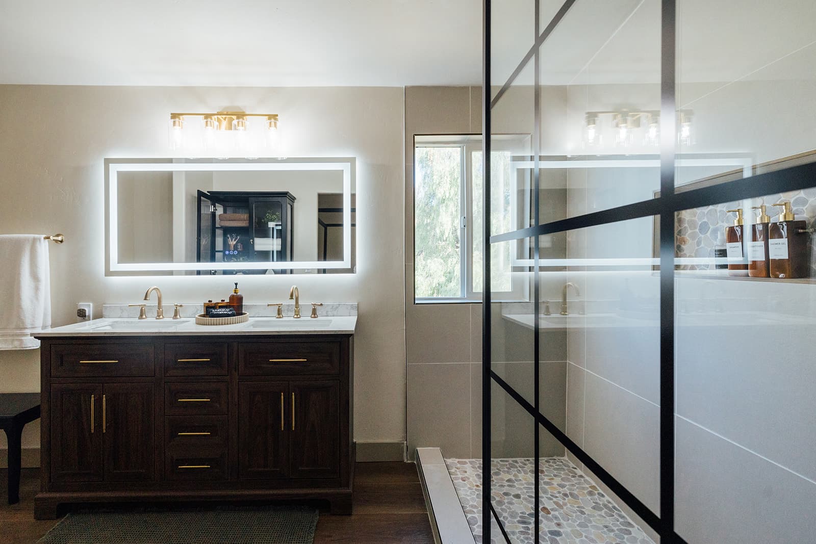 Primary bath with a double vanity and a glass walk-in shower