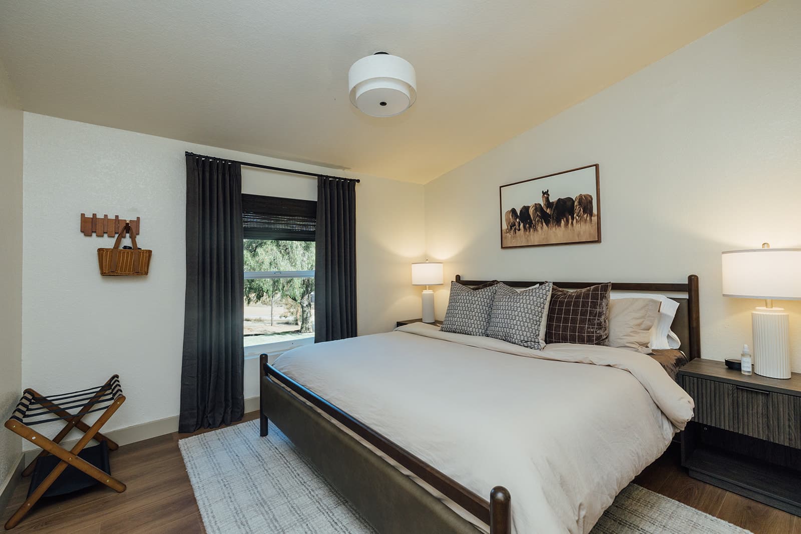 Guest bedroom with a king bed and a framed horse print