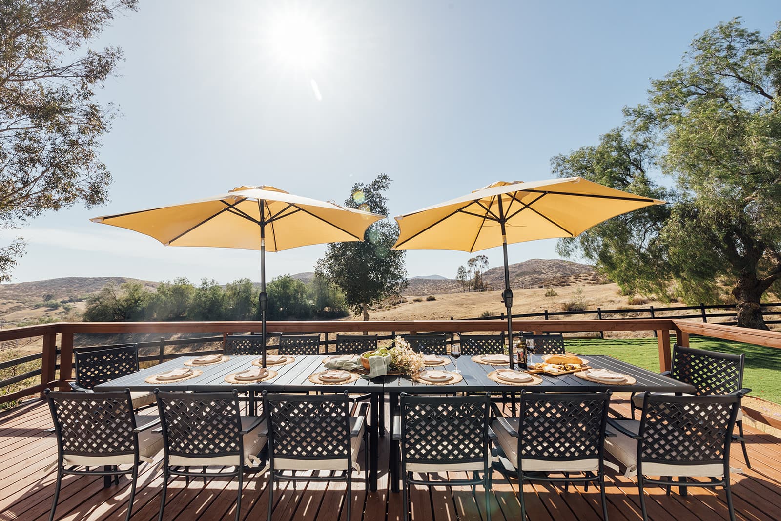 Outdoor dining deck with umbrellas overlooking the valley