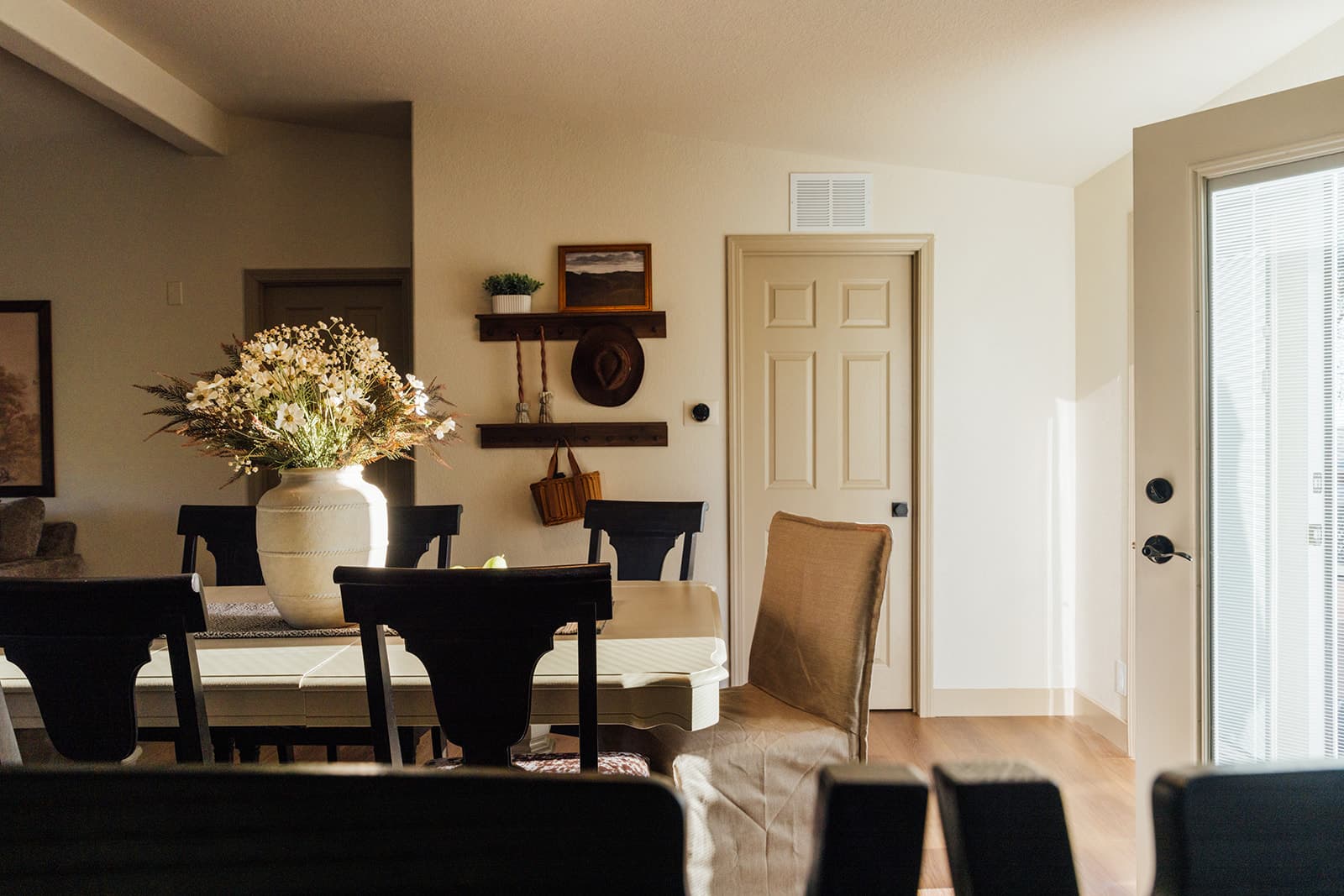 Farmhouse dining table set beneath the hat wall