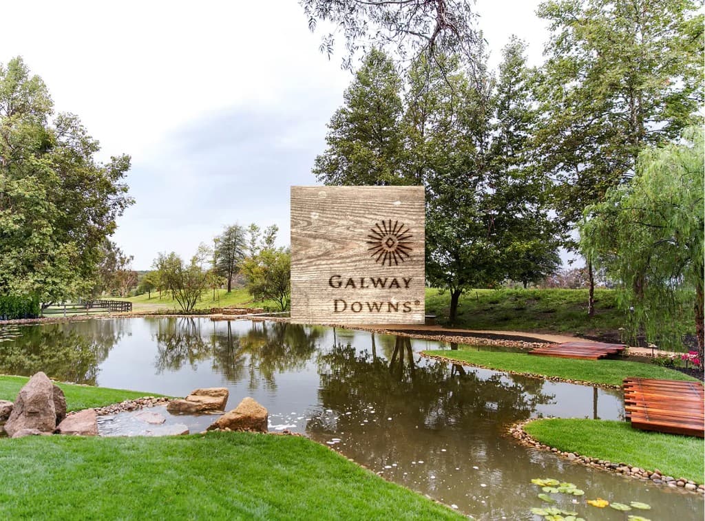 Galway Downs estate with pond, green lawns, and tree-lined grounds